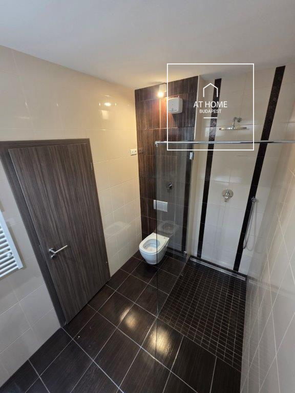 A renovated 95 sqm three-story apartment with a rooftop terrace, located in the 3rd district