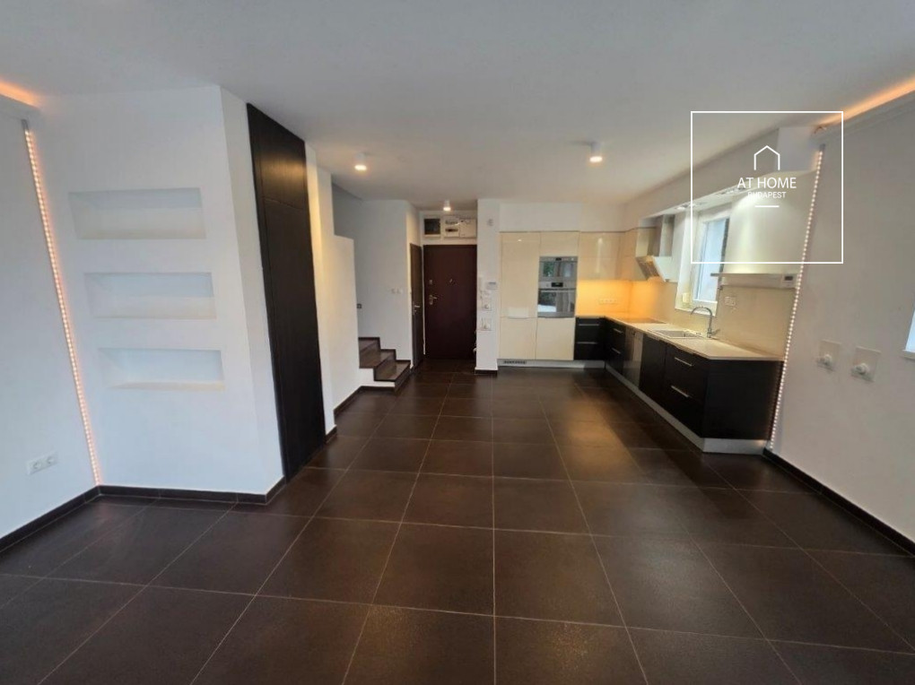 A renovated 95 sqm three-story apartment with a rooftop terrace, located in the 3rd district