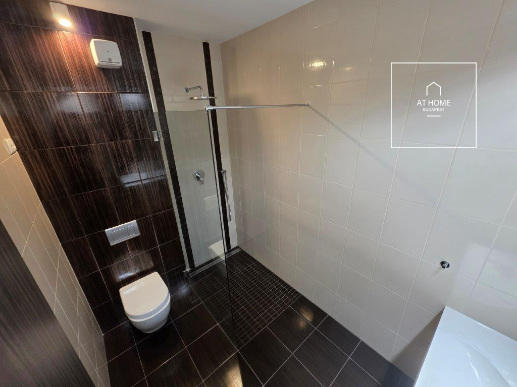 A renovated 95 sqm three-story apartment with a rooftop terrace, located in the 3rd district