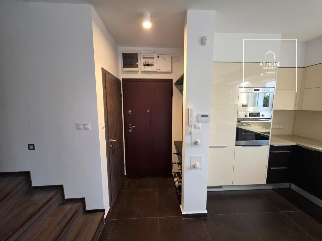 A renovated 97 sqm three-story apartment with a rooftop terrace, located in the 3rd district