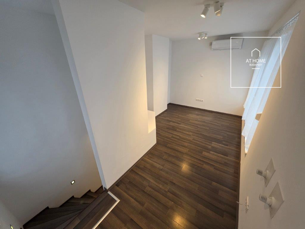 A renovated 97 sqm three-story apartment with a rooftop terrace, located in the 3rd district